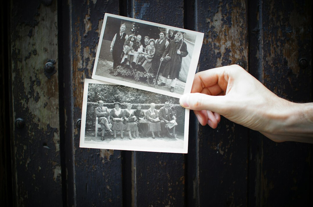 hands holding old photo album