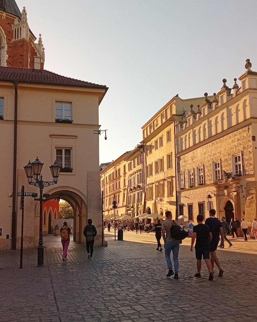 Old town street in Poland with pedestrians walking