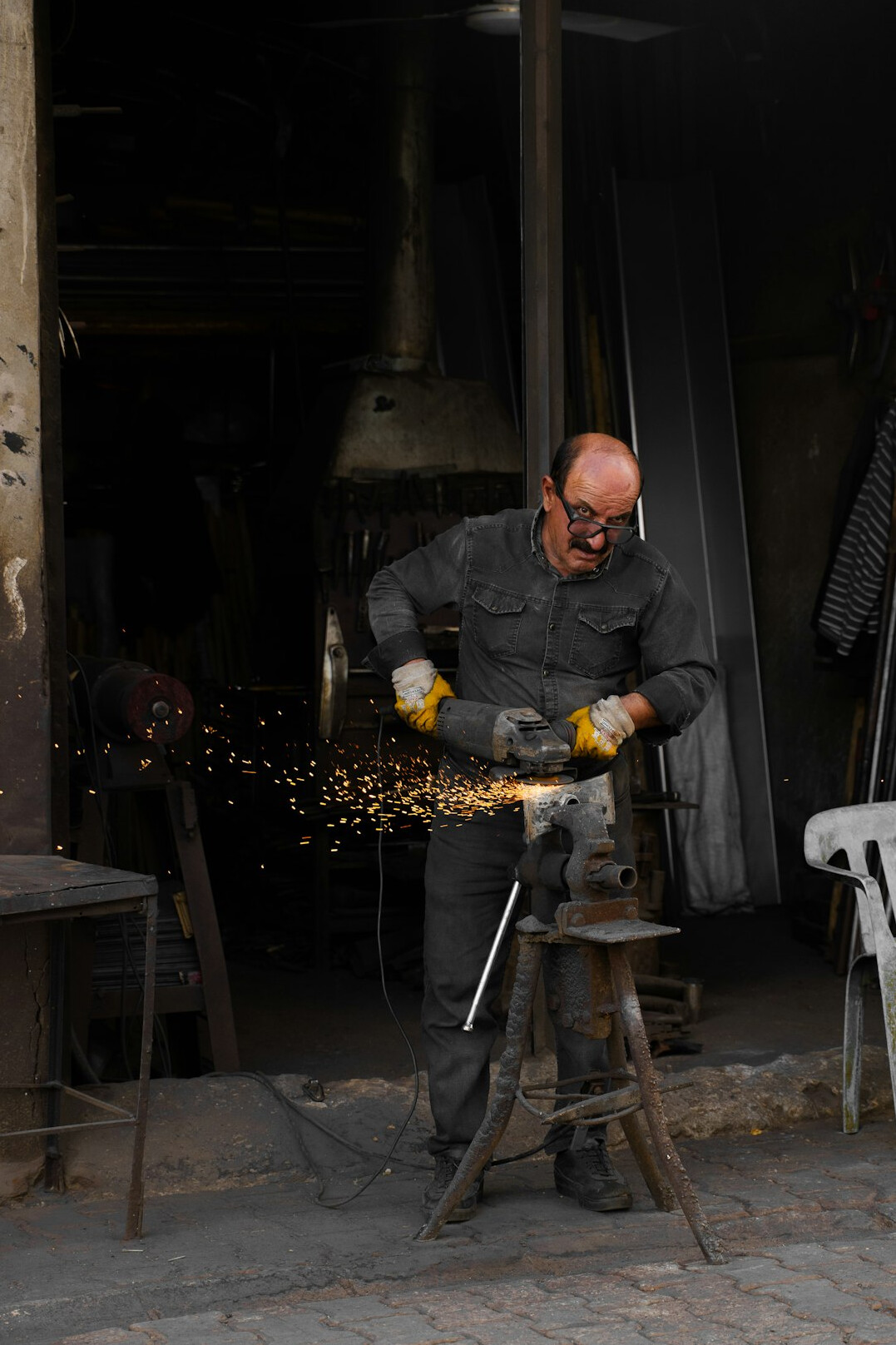 Polish blacksmith working with metal in a traditional workshop